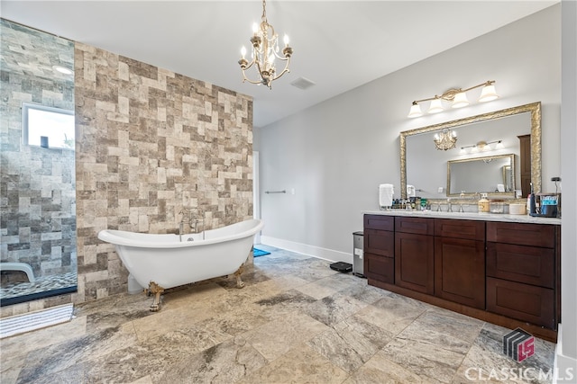 bathroom featuring tile walls, vanity, baseboards, a soaking tub, and a notable chandelier