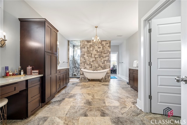 bathroom featuring a notable chandelier, stone finish floor, vanity, a soaking tub, and a shower