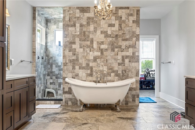 full bathroom with vanity, baseboards, a soaking tub, a notable chandelier, and tiled shower