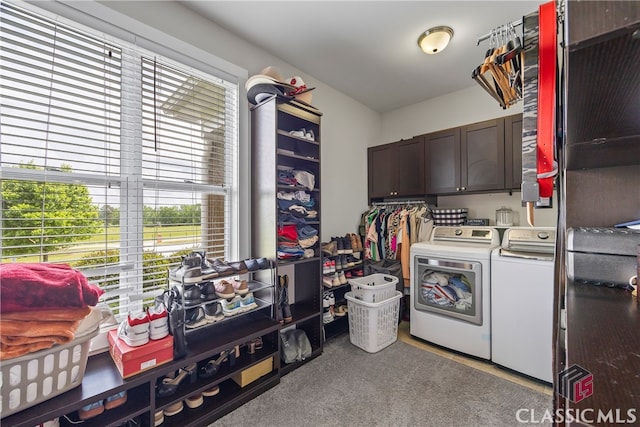 laundry room with a healthy amount of sunlight, separate washer and dryer, and cabinet space