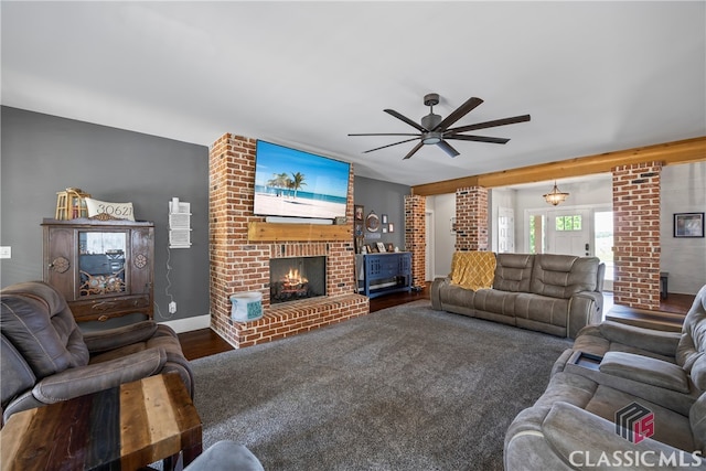 living area with a fireplace, baseboards, and a ceiling fan