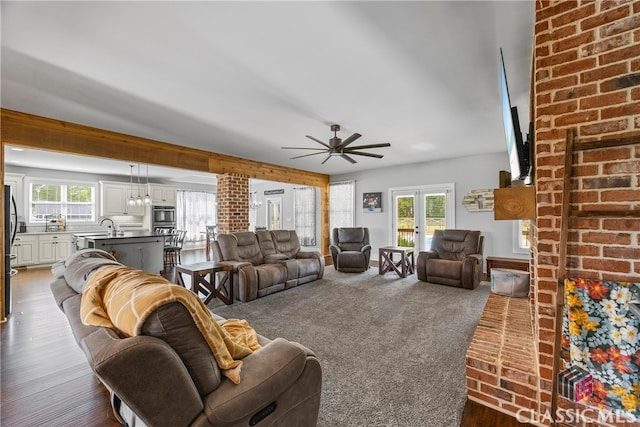 living room with dark wood-style flooring and a ceiling fan