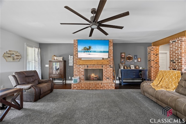 living room with dark colored carpet, a ceiling fan, and a brick fireplace