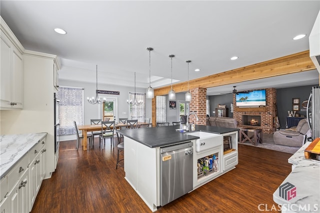 kitchen with a sink, dark wood finished floors, a fireplace, recessed lighting, and dishwasher