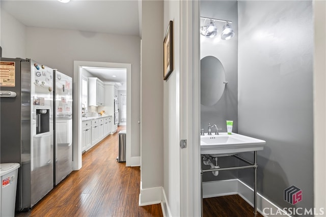 corridor with baseboards and dark wood-style floors