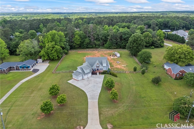 drone / aerial view featuring a forest view
