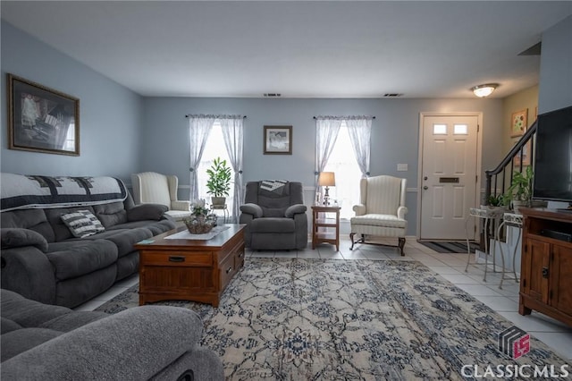 living room featuring visible vents and light tile patterned flooring