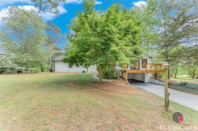 exterior space featuring driveway, a front lawn, a deck, and a carport