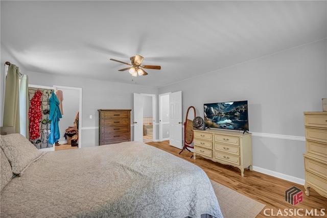 bedroom with wood finished floors, baseboards, and ceiling fan