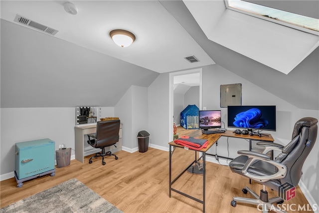 office with wood finished floors, lofted ceiling, electric panel, and baseboards