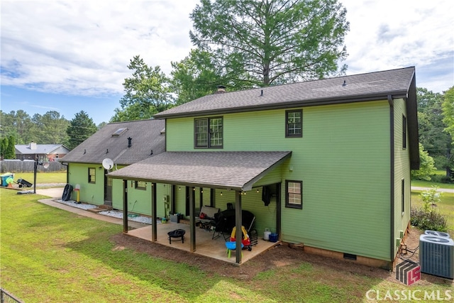 back of property featuring a patio area, a yard, central air condition unit, crawl space, and roof with shingles