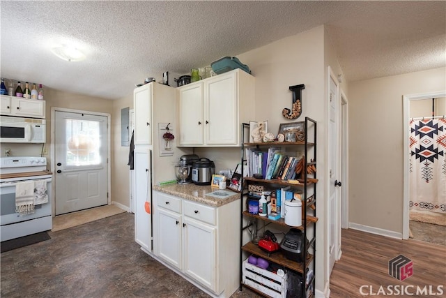 35 Good Hope Rd, Colbert, GA 30628 - kitchen featuring white appliances, a textured ceiling, white cabinetry, baseboards, and electric panel