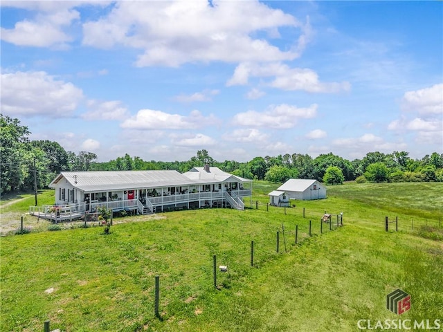 3081 Macedonia Rd, Union Point, GA 30669 - back of house featuring an outdoor structure, an outbuilding, view of scattered trees, and covered porch