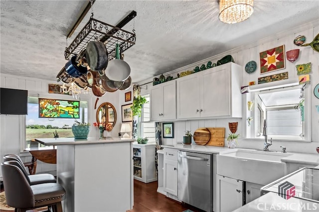 3081 Macedonia Rd, Union Point, GA 30669 - kitchen featuring stainless steel dishwasher, a chandelier, a textured ceiling, a sink, and light countertops
