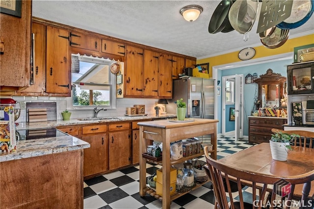 3081 Macedonia Rd, Union Point, GA 30669 - kitchen with light flooring, brown cabinetry, a sink, ornamental molding, and backsplash