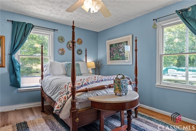 3081 Macedonia Rd, Union Point, GA 30669 - bedroom with wood finished floors, baseboards, a ceiling fan, and a textured ceiling