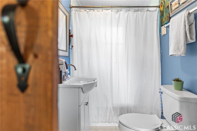 3081 Macedonia Rd, Union Point, GA 30669 - full bath with toilet, vanity, a shower with shower curtain, and tile patterned flooring