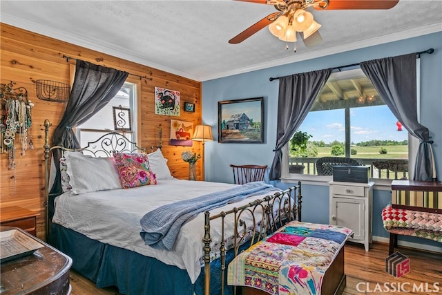3081 Macedonia Rd, Union Point, GA 30669 - bedroom with wood walls, wood finished floors, crown molding, and ceiling fan