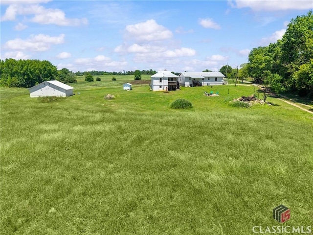 3081 Macedonia Rd, Union Point, GA 30669 - view of grassy yard featuring an outdoor structure and a view of rural / pastoral area