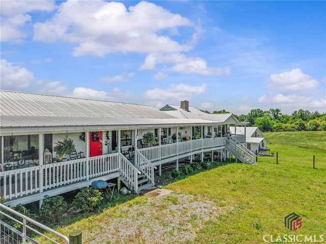 3081 Macedonia Rd, Union Point, GA 30669 - view of front of house with metal roof, a chimney, a front lawn, and stairway