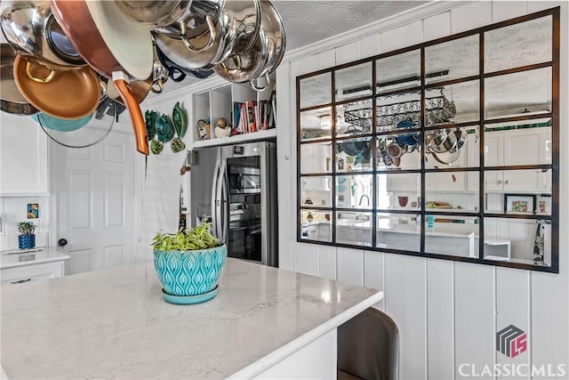 3081 Macedonia Rd, Union Point, GA 30669 - kitchen featuring stainless steel refrigerator with ice dispenser, white cabinets, crown molding, a textured ceiling, and light stone countertops