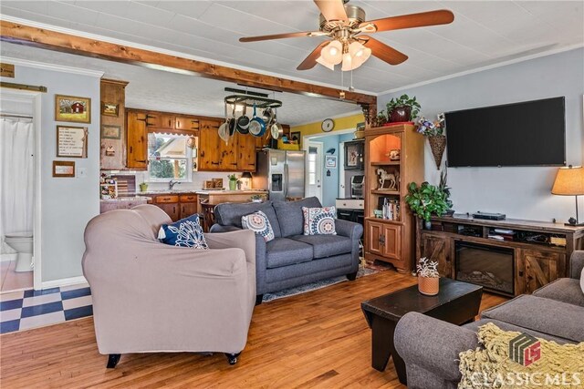 3081 Macedonia Rd, Union Point, GA 30669 - living room featuring a ceiling fan, crown molding, and light wood-type flooring