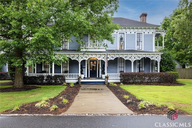 172 N Second St, Madison, GA 30650 - italianate-style house featuring a porch and a chimney