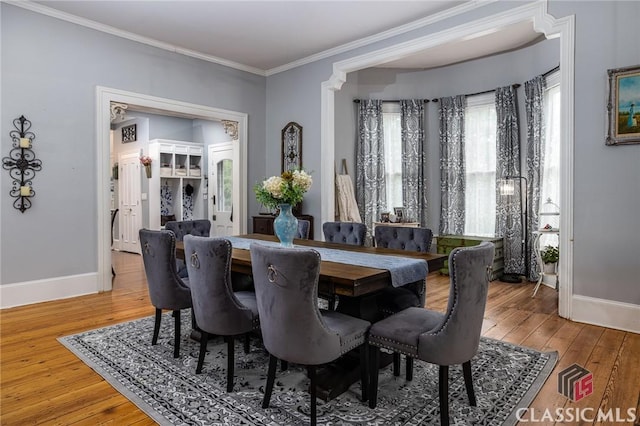 172 N Second St, Madison, GA 30650 - dining room featuring baseboards, light wood-style flooring, and ornamental molding