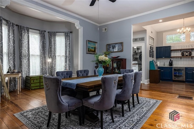 172 N Second St, Madison, GA 30650 - dining space featuring beverage cooler, hardwood / wood-style floors, a chandelier, ornamental molding, and a ceiling fan