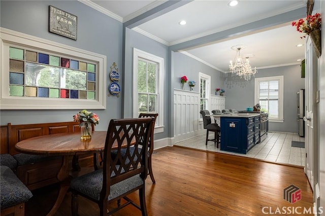 172 N Second St, Madison, GA 30650 - dining space featuring a chandelier, light wood finished floors, crown molding, and baseboards