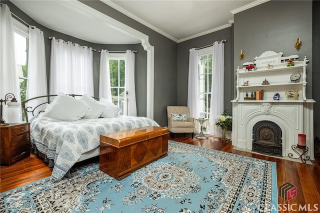 172 N Second St, Madison, GA 30650 - bedroom featuring wood finished floors, multiple windows, ornamental molding, a fireplace, and access to outside