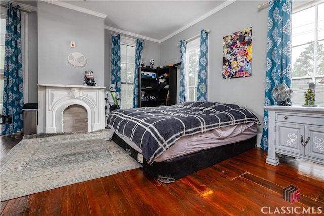 172 N Second St, Madison, GA 30650 - bedroom with hardwood / wood-style flooring, crown molding, and a fireplace
