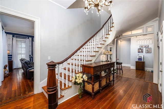 172 N Second St, Madison, GA 30650 - staircase with a chandelier, hardwood / wood-style floors, baseboards, crown molding, and lofted ceiling