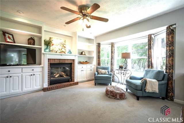 1181 Pete Dickens Rd, Bogart, GA 30622 - living area with carpet flooring, a brick fireplace, ceiling fan, a textured ceiling, and built in features