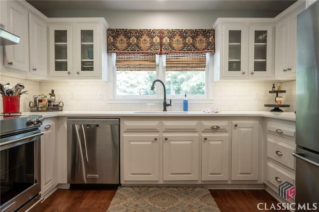 1181 Pete Dickens Rd, Bogart, GA 30622 - kitchen featuring stainless steel appliances, white cabinetry, light countertops, dark wood-style floors, and backsplash