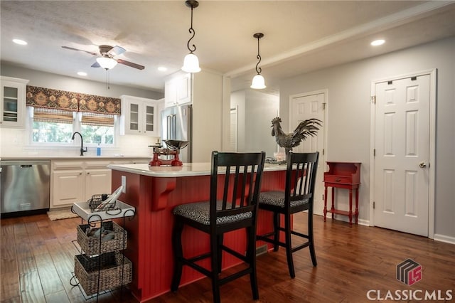 1181 Pete Dickens Rd, Bogart, GA 30622 - kitchen with stainless steel appliances, white cabinetry, light countertops, dark wood-style flooring, and recessed lighting