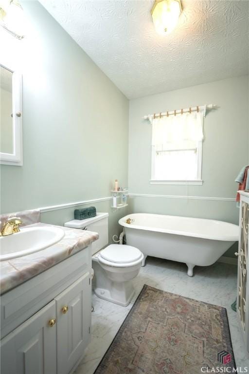 1181 Pete Dickens Rd, Bogart, GA 30622 - bathroom with vanity, a freestanding bath, a textured ceiling, toilet, and marble finish flooring