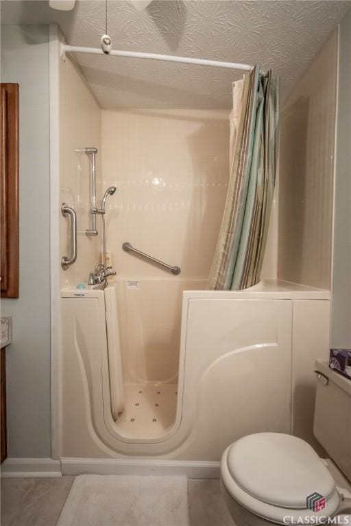 1181 Pete Dickens Rd, Bogart, GA 30622 - full bath featuring a shower stall, tile patterned floors, and a textured ceiling