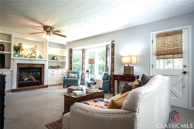 1181 Pete Dickens Rd, Bogart, GA 30622 - living room featuring plenty of natural light, a ceiling fan, a brick fireplace, a textured ceiling, and light colored carpet