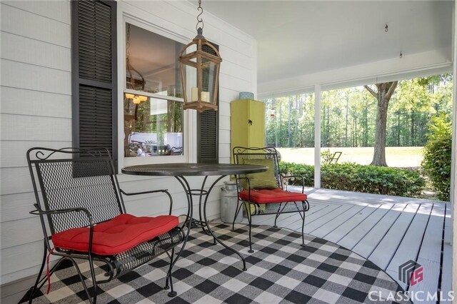 1181 Pete Dickens Rd, Bogart, GA 30622 - wooden deck featuring a porch, outdoor dining space, and ceiling fan