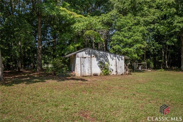 1181 Pete Dickens Rd, Bogart, GA 30622 - view of grassy yard featuring a storage unit and an outbuilding