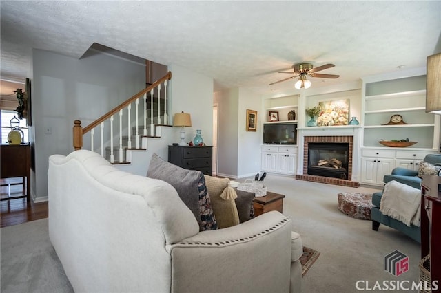 1181 Pete Dickens Rd, Bogart, GA 30622 - living area featuring a ceiling fan, carpet flooring, baseboards, a brick fireplace, and stairs