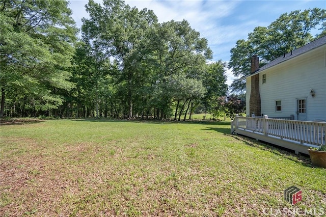1181 Pete Dickens Rd, Bogart, GA 30622 - view of green lawn with a wooden deck and view of scattered trees