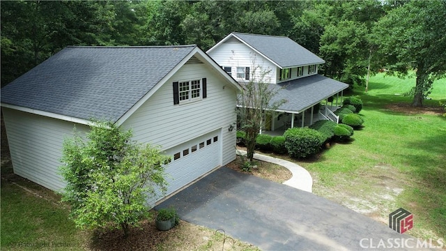 1181 Pete Dickens Rd, Bogart, GA 30622 - view of front of house with a garage, a front lawn, asphalt driveway, a porch, and roof with shingles