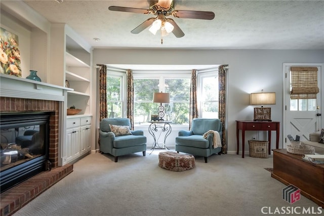 1181 Pete Dickens Rd, Bogart, GA 30622 - living area featuring light colored carpet, ceiling fan, a fireplace, and a textured ceiling