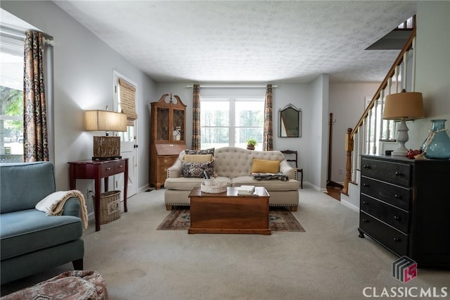 1181 Pete Dickens Rd, Bogart, GA 30622 - living area featuring plenty of natural light, light carpet, stairway, a textured ceiling, and baseboards