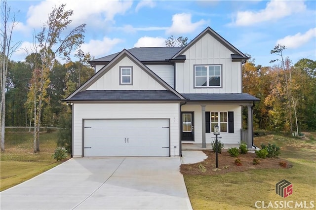 132 Water Oak Way, Crawford, GA 30630 - view of front of house with board and batten siding, driveway, a front yard, and a porch