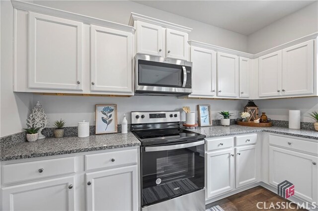 132 Water Oak Way, Crawford, GA 30630 - kitchen featuring stainless steel appliances, white cabinetry, light stone counters, and dark wood-style floors