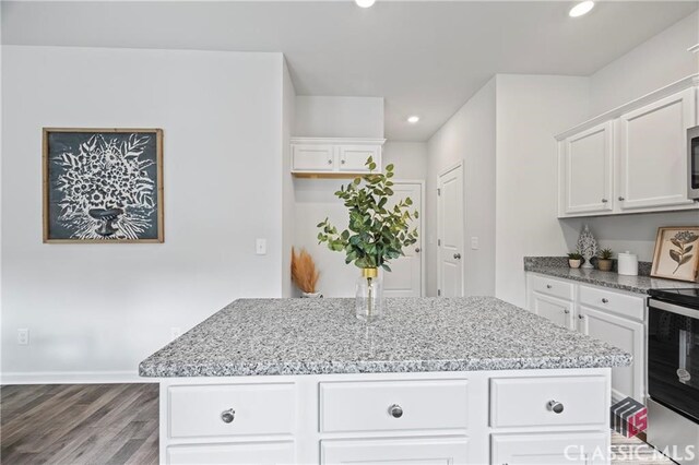 132 Water Oak Way, Crawford, GA 30630 - kitchen with stainless steel appliances, recessed lighting, a center island, wood finished floors, and light stone countertops