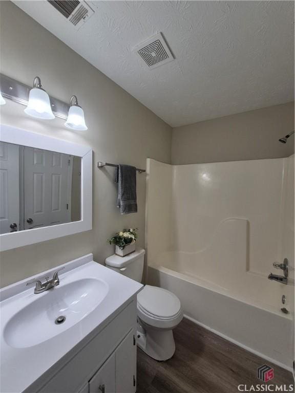 115 Big Oak Cir, Athens, GA 30605 - bathroom with wood finished floors, tub / shower combination, vanity, toilet, and a textured ceiling